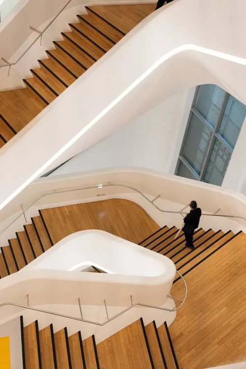Architectural staircase rising through a contemporary office