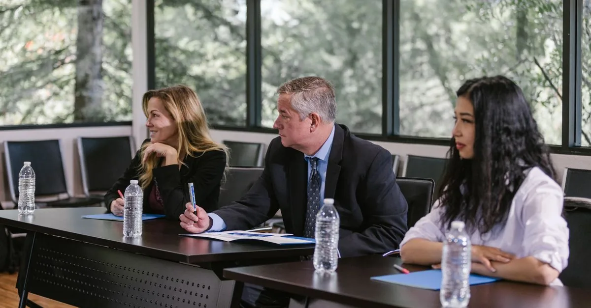 Professionals arranging collaboration materials around a table